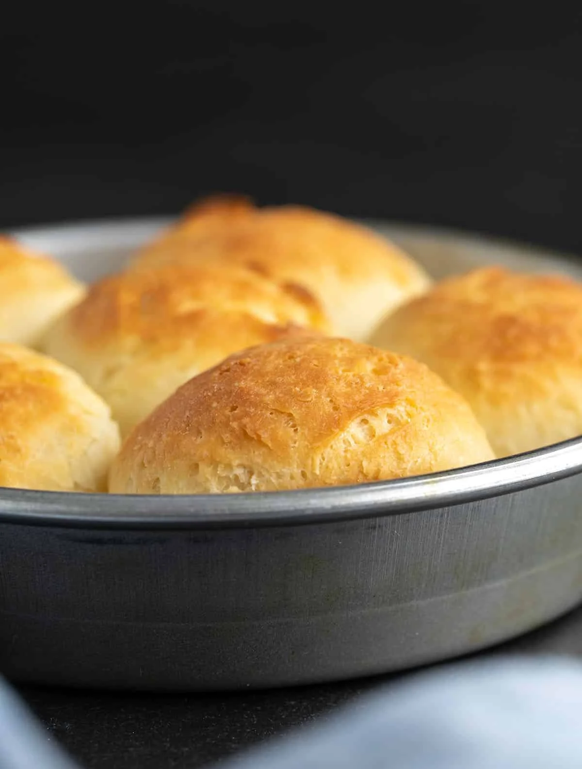 Close up of the tops of several rolls in the tin after baking. 