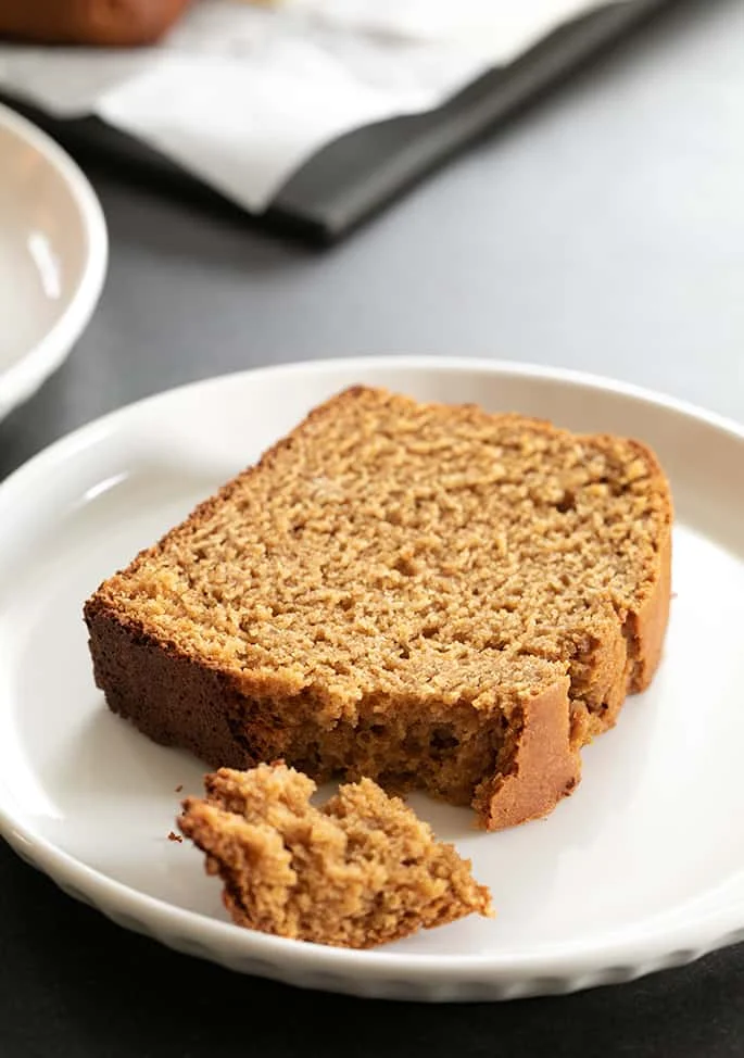 Closeup image of a slice of gluten free gingerbread loaf, showing the tenderness of the crumb. 