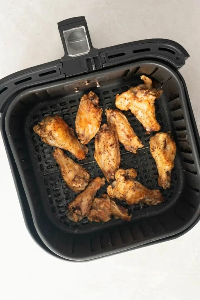 cooked air fryer wings in basket.