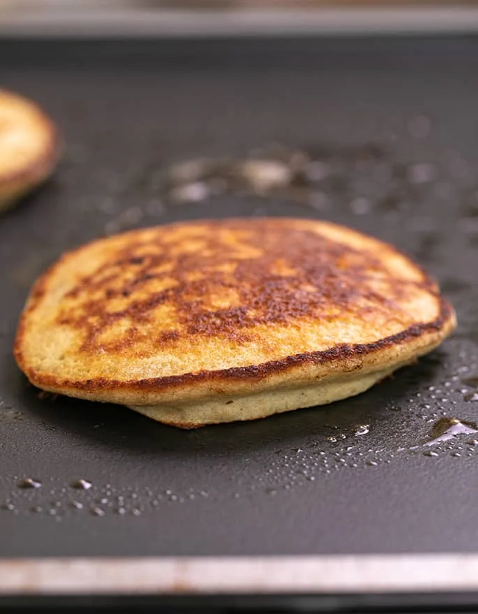 Cooked pancake on hot skillet.