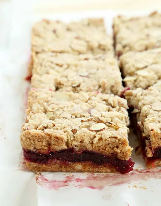Cranberry jam bars on a white surface 