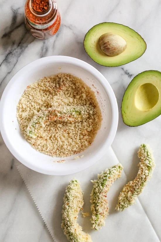Crispy baked avocado fries coated with crispy panko breadcrumbs with a lime dipping sauce. So fast and easy to make in the oven or air fryer!
