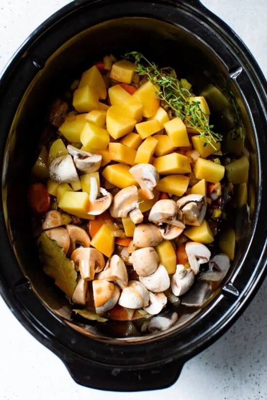 crock pot with beef potatoes and veggies