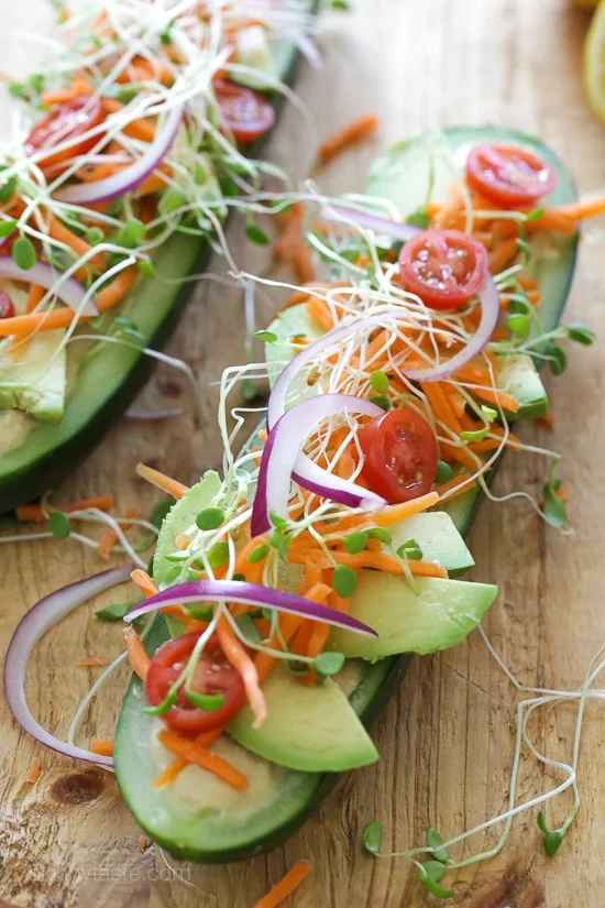 Cucumbers with the seeds scooped out and filled with hummus, avocado, tomatoes, onion and sprouts. So refreshing, healthy and light!