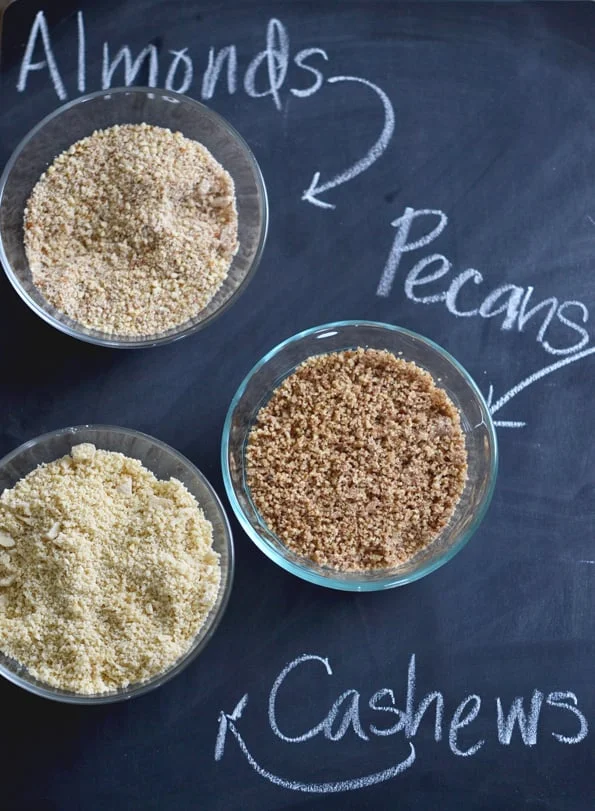 Different nut flours on black surface