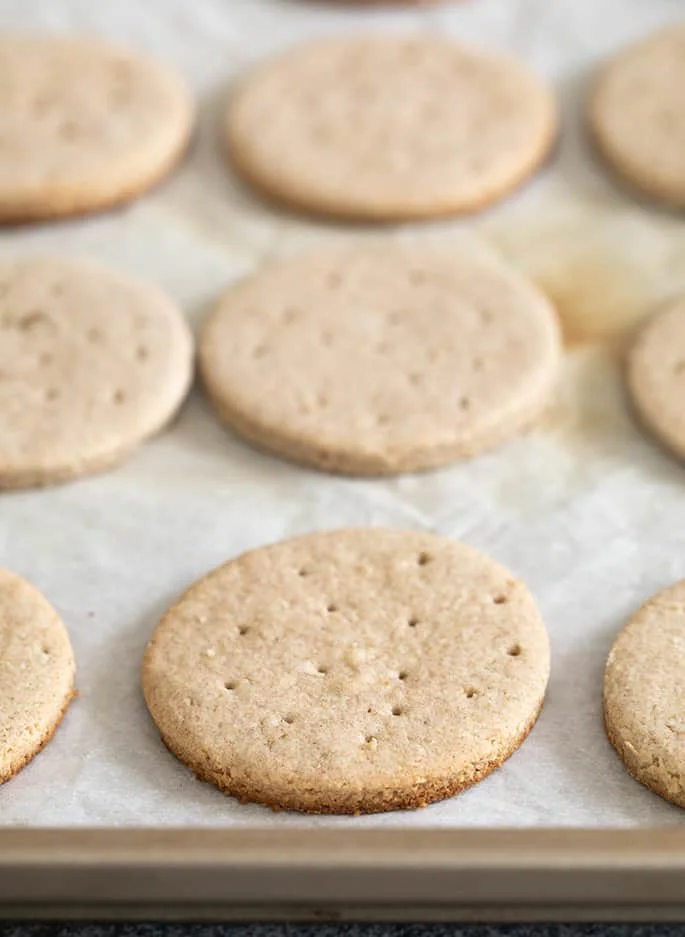 Digestive biscuits baked on white paper on tray