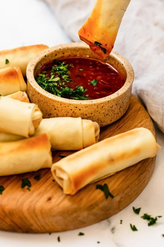 dipping egg rolls in salsa