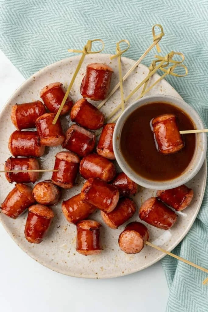 dipping smoked sausage into sauce