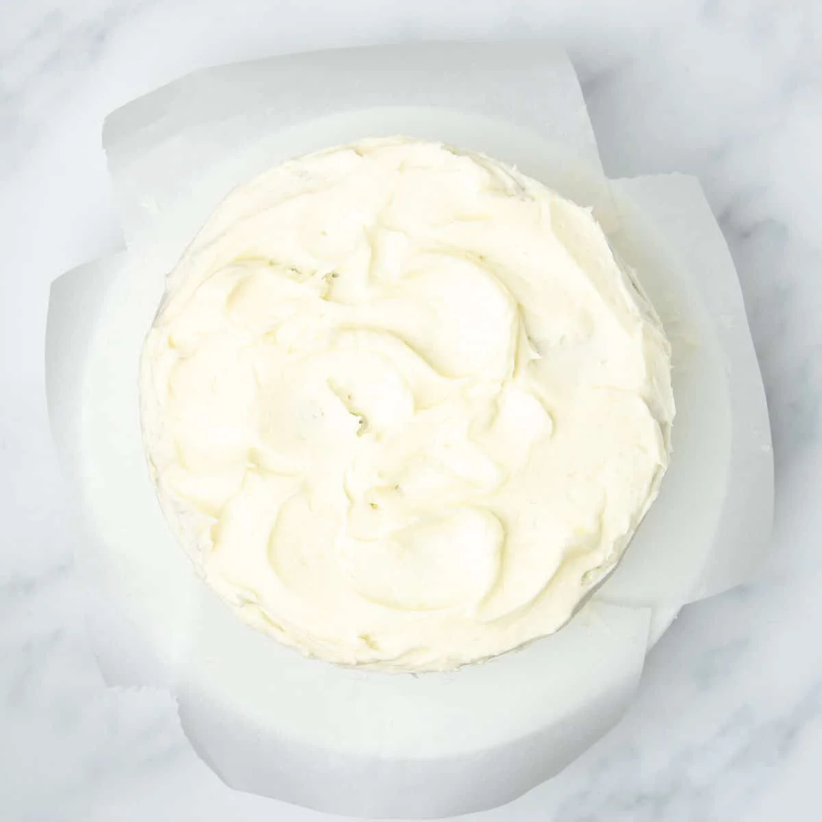 Finished cake with icing spread and swirled.