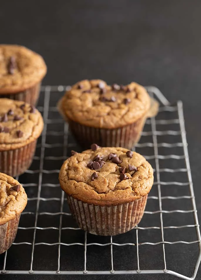 Flourless peanut butter muffins whole muffins on a wire rack.