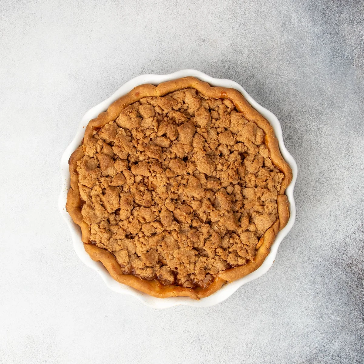 Fully baked pie with a crisp browned crumble topping, just out of the oven.