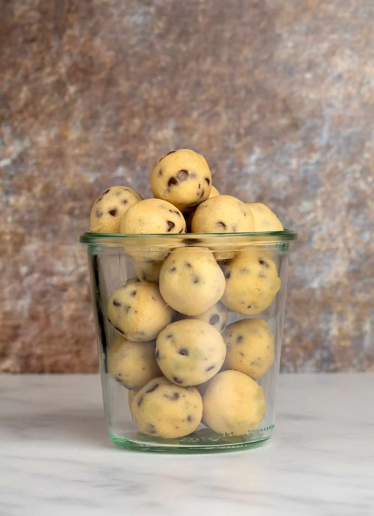 Glass jar filled with neatly rolled balls ready for snacking.