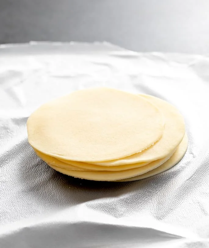 gluten free Chinese food recipe for round gluten free won ton wrappers in stack on plastic wrap