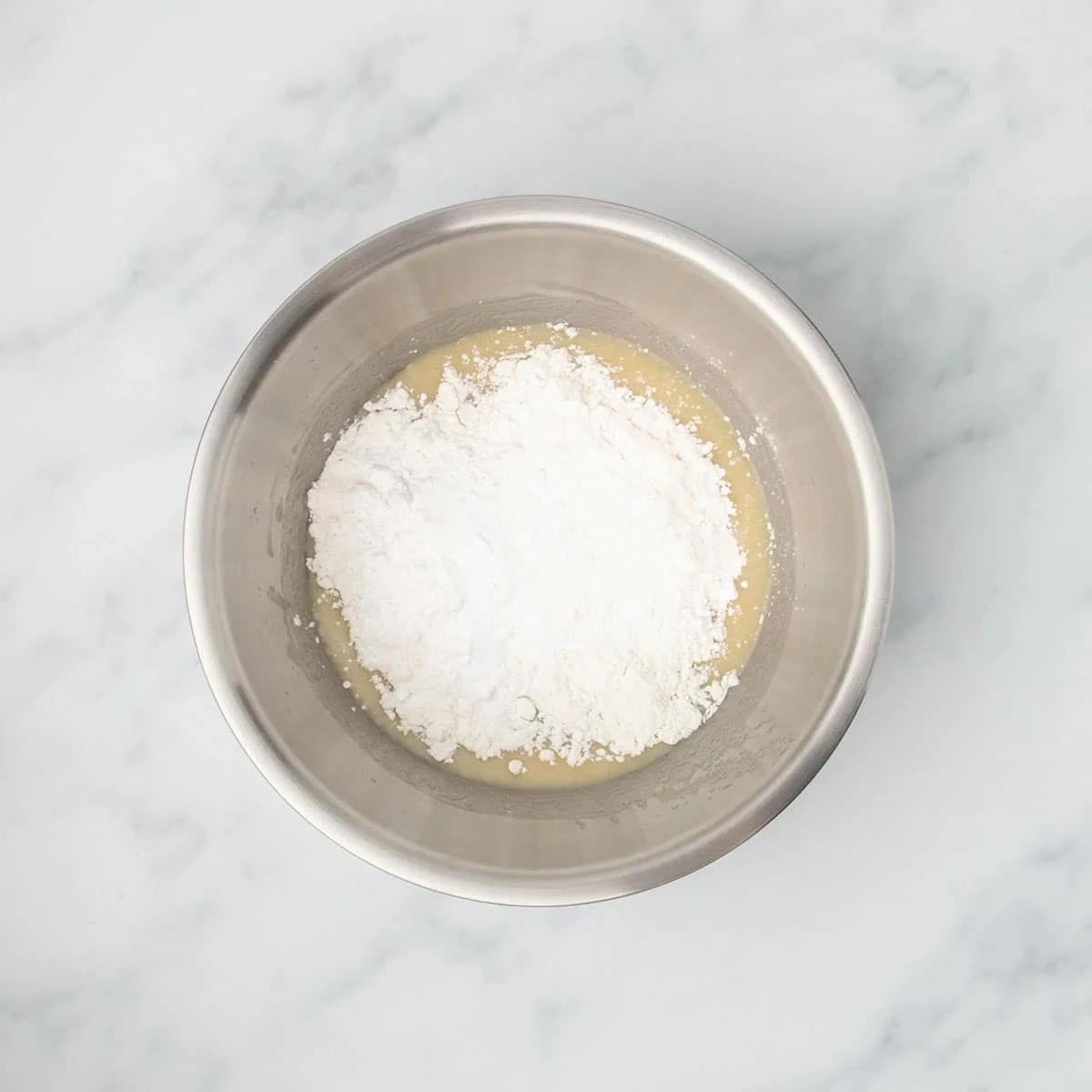 Gluten free flour, starch, baking powder, baking soda and salt added to the wet mixture in the same bowl.