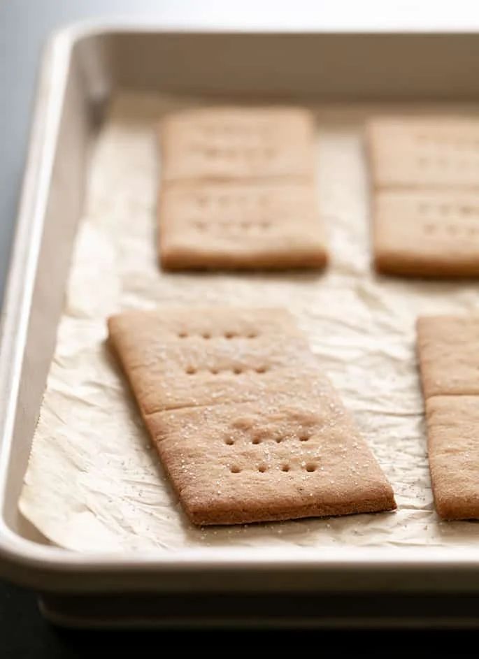 Gluten free graham crackers baked on tray on brown paper