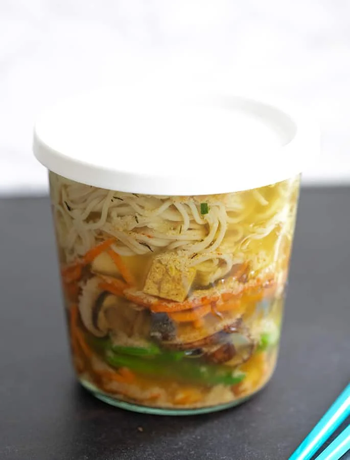 Gluten free ramen noodles soup steeping with the cover on.