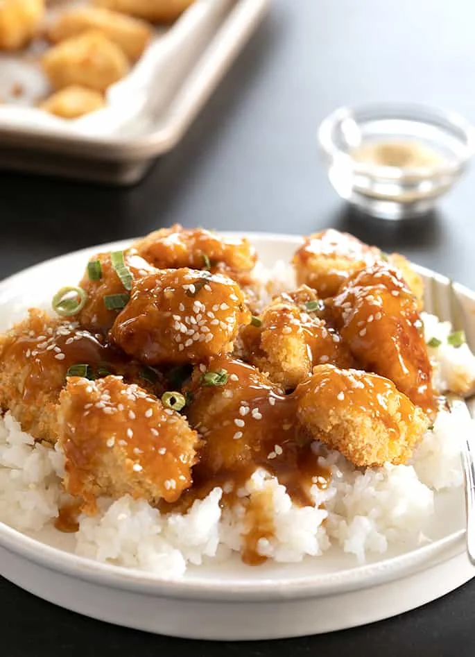 Gluten free sesame chicken being served.