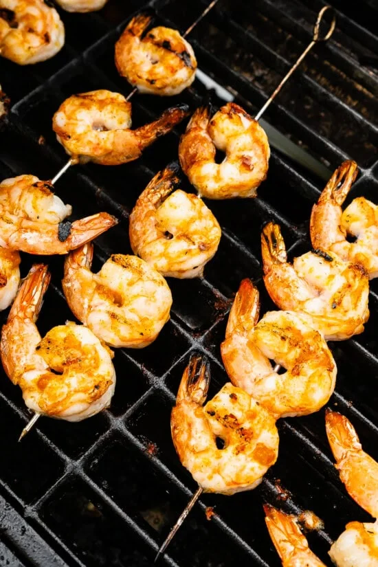 Grill until opaque and cooked through, then brush on garlic butter.