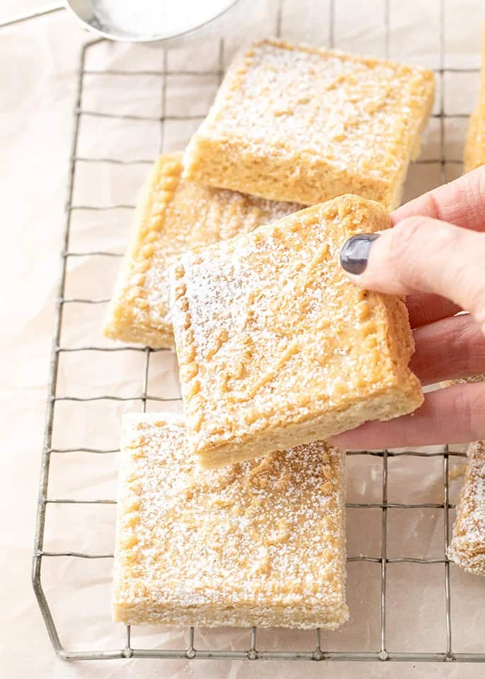 Hand holding square of shortbread