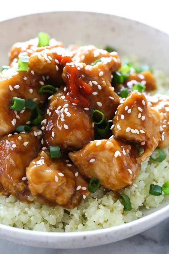 Healthy General Tso's chicken served over cauliflower rice