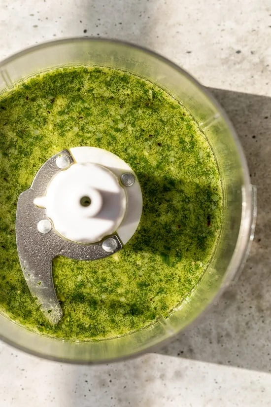 Homemade basil pesto in food processor bowl