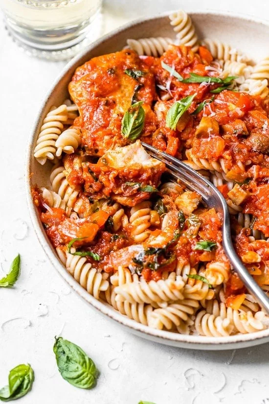 Homemade Italian chicken cacciatore served over pasta.