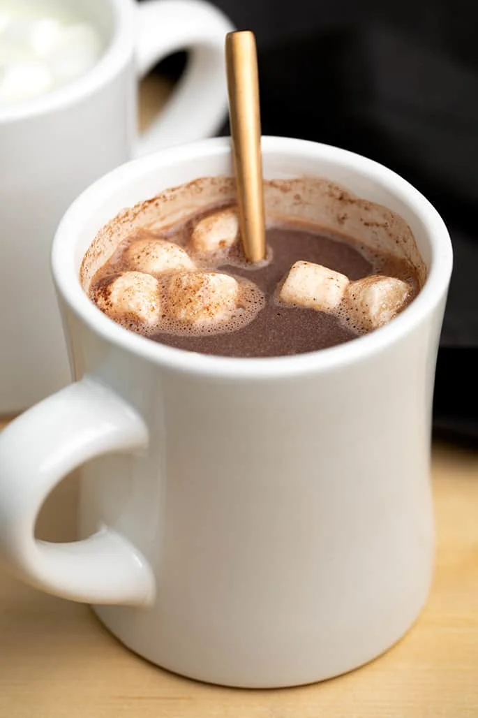 Hot Chocolate with 6 mini marshmallows in white mug with gold spoon handle