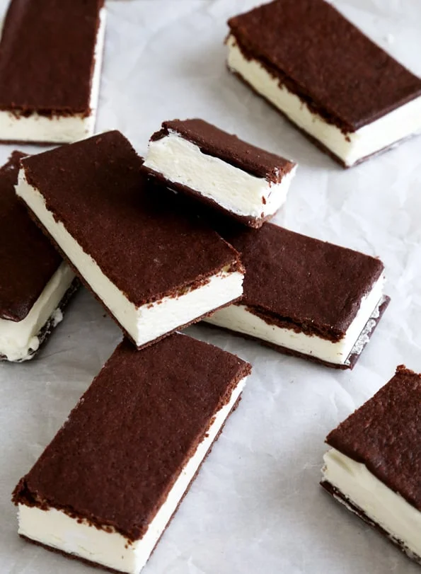 Ice cream sandwiches leaning against each other on white surface 