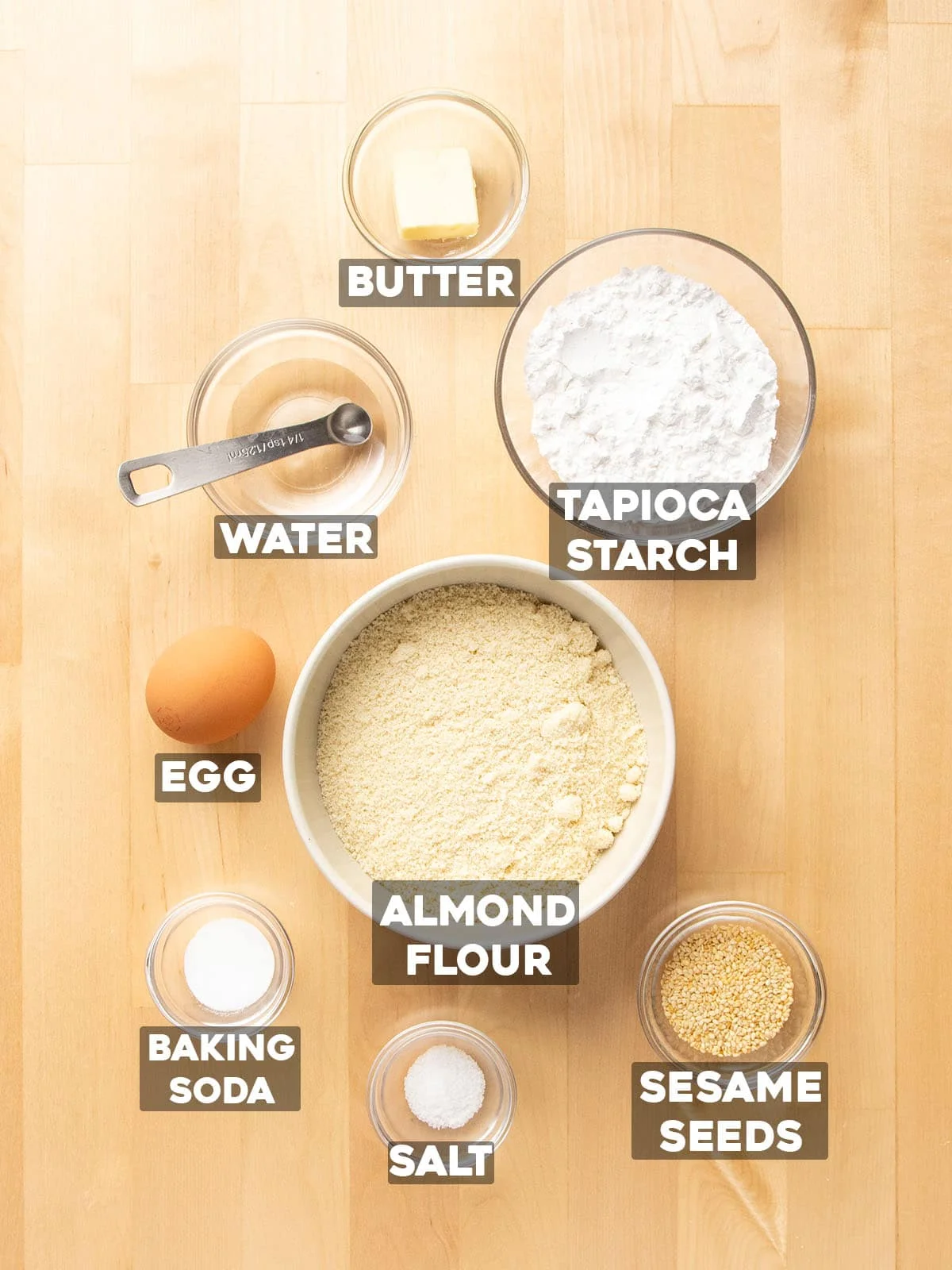 ingredients for almond flour crackers in small bowls with ingredient names