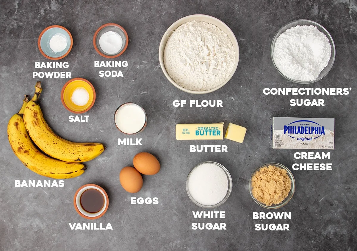 ingredients for gluten free banana cake in small bowls with white block letters spelling out the name of each ingredient