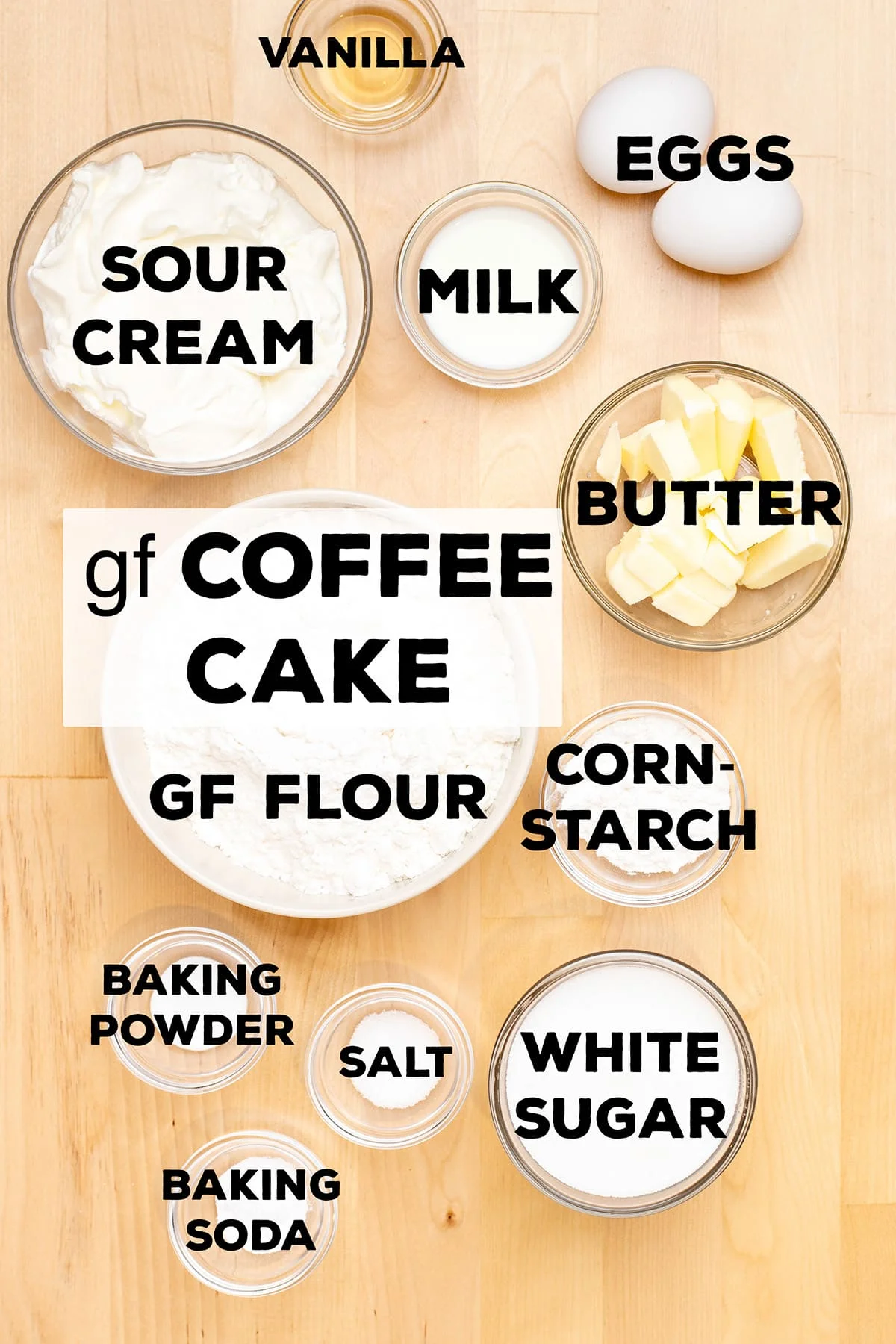 ingredients for gluten free coffee cake including sour cream, milk, butter, gf flour, cornstarch, baking powder, salt, baking soda, and sugar in small bowls with words on top