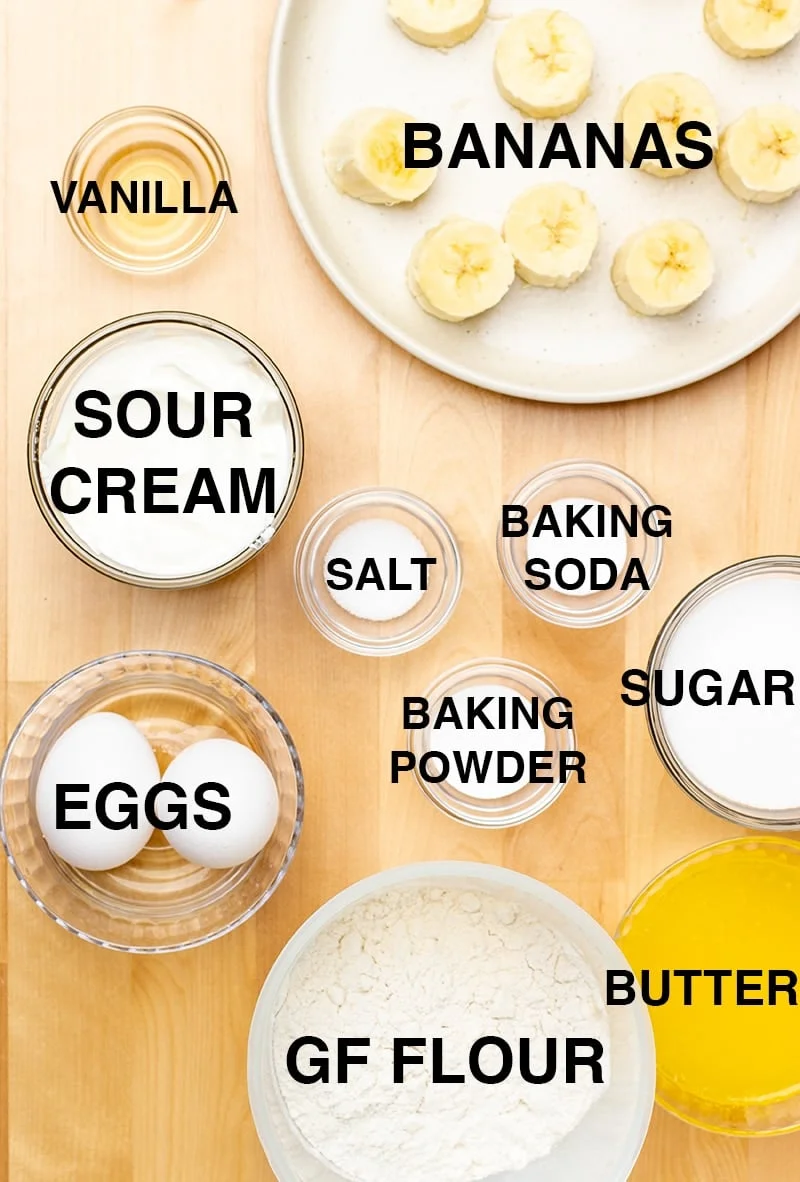 Ingredients for the recipe including sliced bananas, vanilla, sour cream, eggs, melted butter and more.
