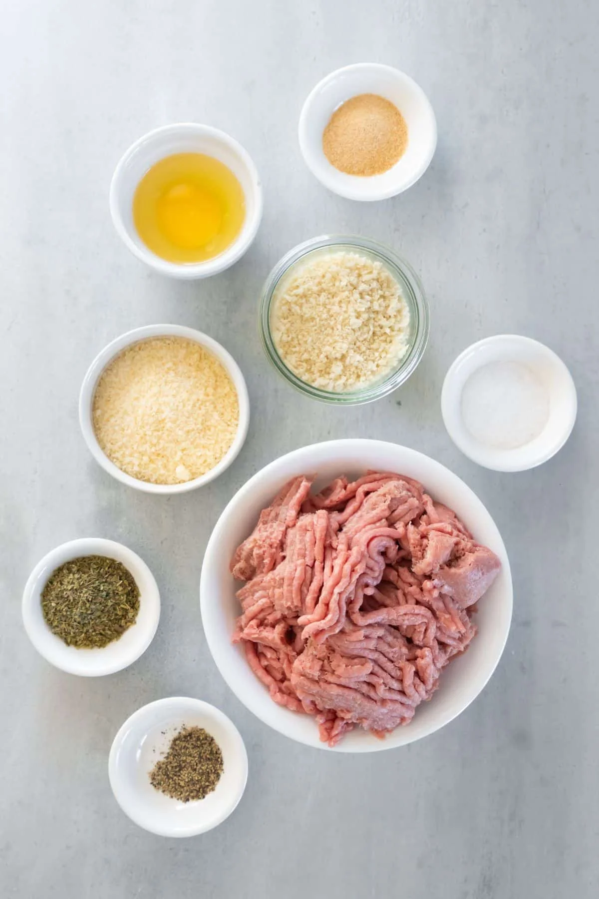 Ingredients needed to make air fryer turkey meatballs: ground turkey, breadcrumbs, parmesan cheese, egg, italian seasoning, garlic powder, salt, and pepper.