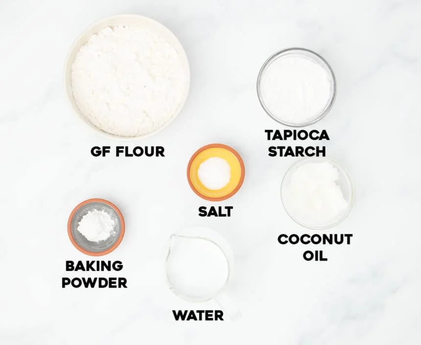 ingredients needed to make gluten free tortillas in small bowls with black block lettering spelling out name of each individual ingredient