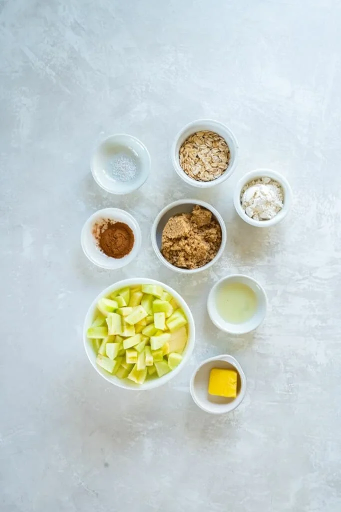 Ingredients needed to prepare an apple crisp in the air fryer.