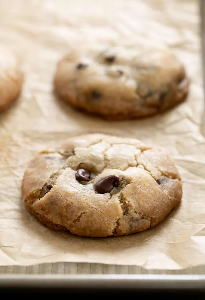 Just baked vegan gluten free chocolate chip cookies, with texture visible close up.