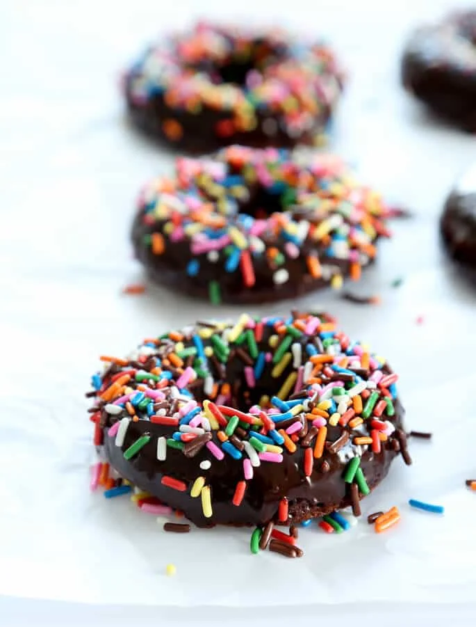 just glazed and decorated chocolate cake donuts from a donut pan