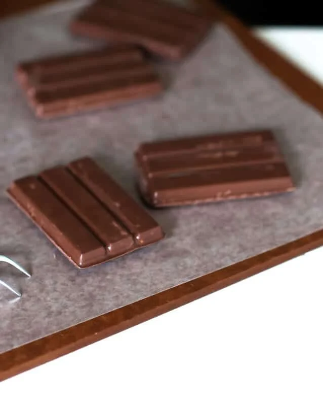 \"kit kat\" bars on a wooden surface