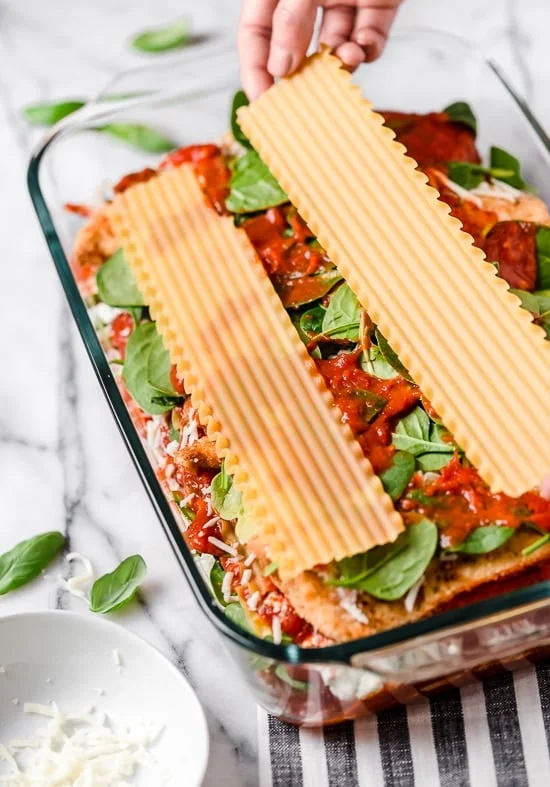 Lasagna noodles layered on top of chicken cutlets