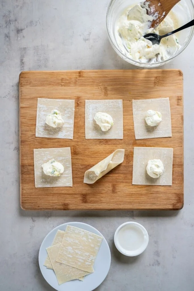 making homemade wontons with filling