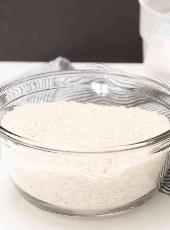 medium size glass bowl with raw long grain white rice