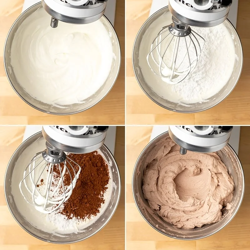 Metal bowl in stand mixer with whipped cream, topped with confectioners' sugar, cocoa powder, and beaten into chocolate whipped cream