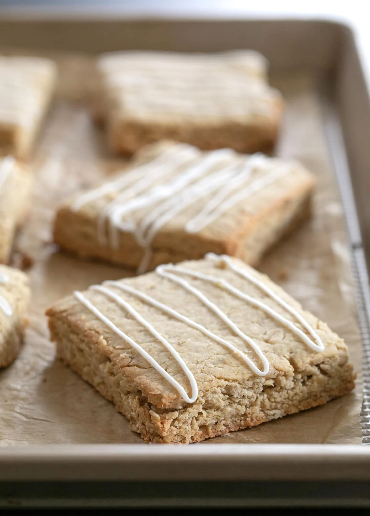Oatmeal bars with icing drizzle on tray