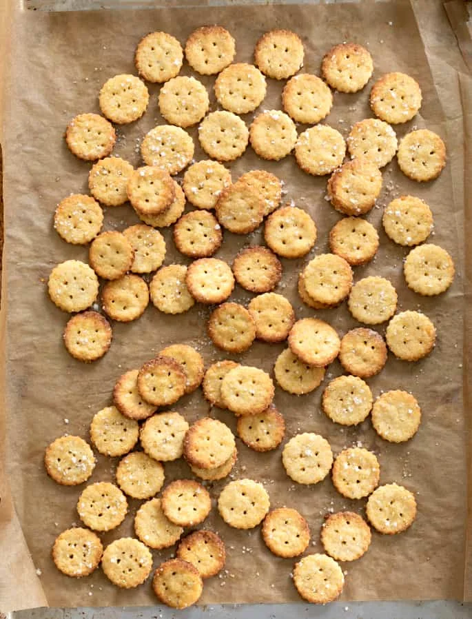 Overhead image of gluten free Parmesan crackers baked on a tray.