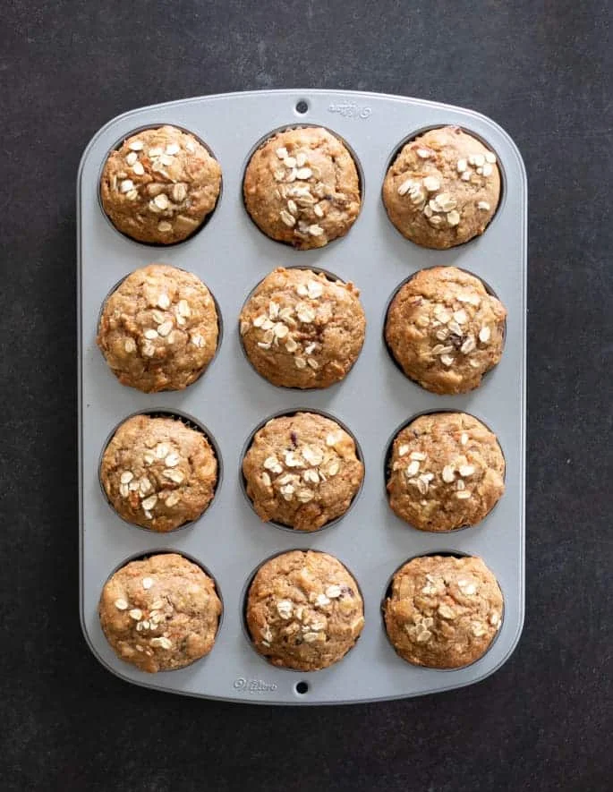 Overhead image of morning glory muffins baked in a muffin tin