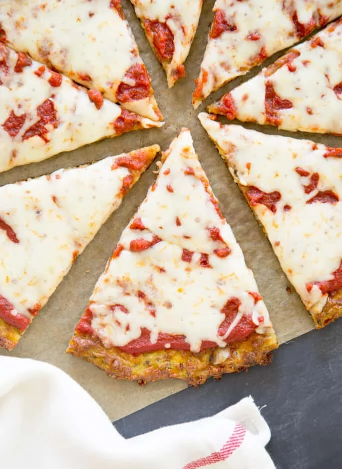 Overhead image of slices of zucchini pizza crust on brown paper
