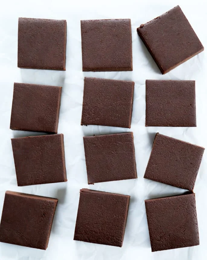 Overhead view of 4 rows of fudge on white surface 