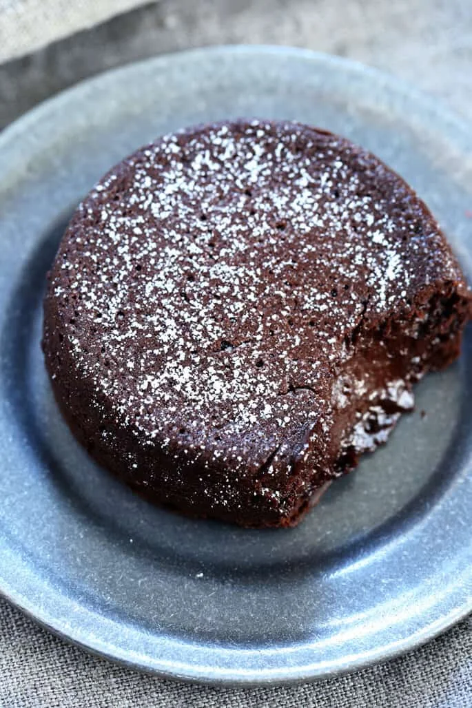 Overhead view of a chocolate lava cake on a gray plate