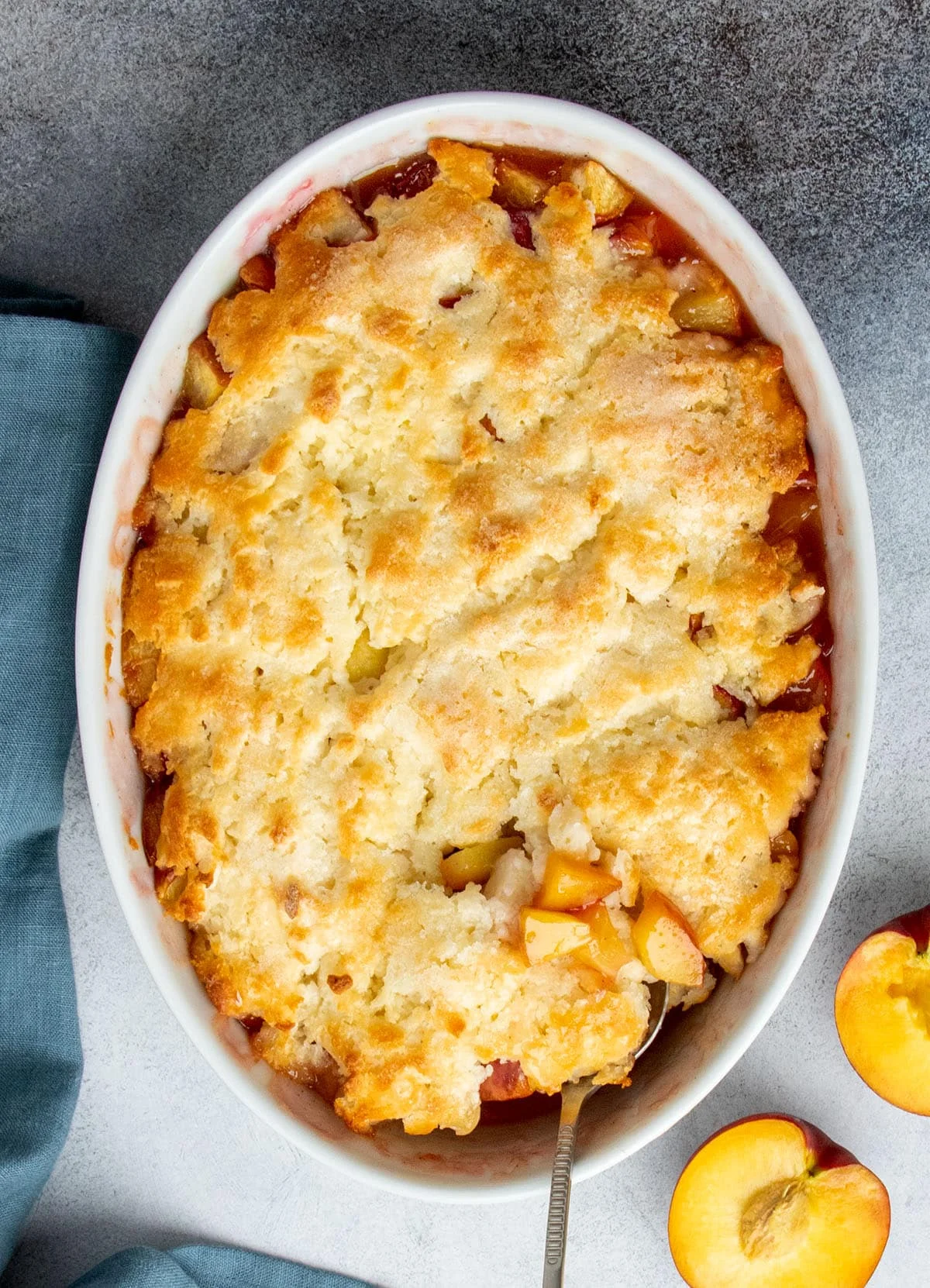 Overhead view of a freshly baked  cobbler with crisp golden topping and bubbling fruit at the edges.
