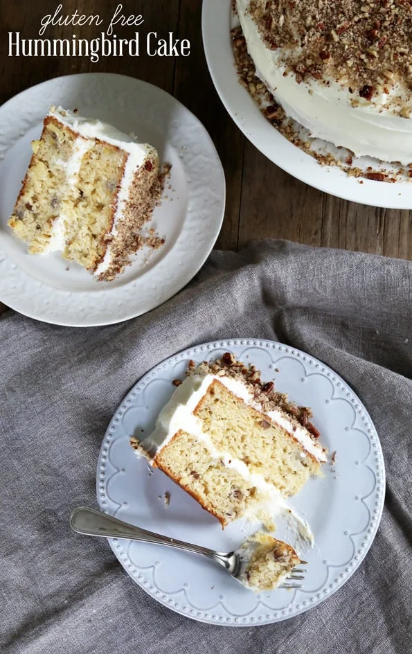 Overhead view of a piece of hummingbird cake on a white plate